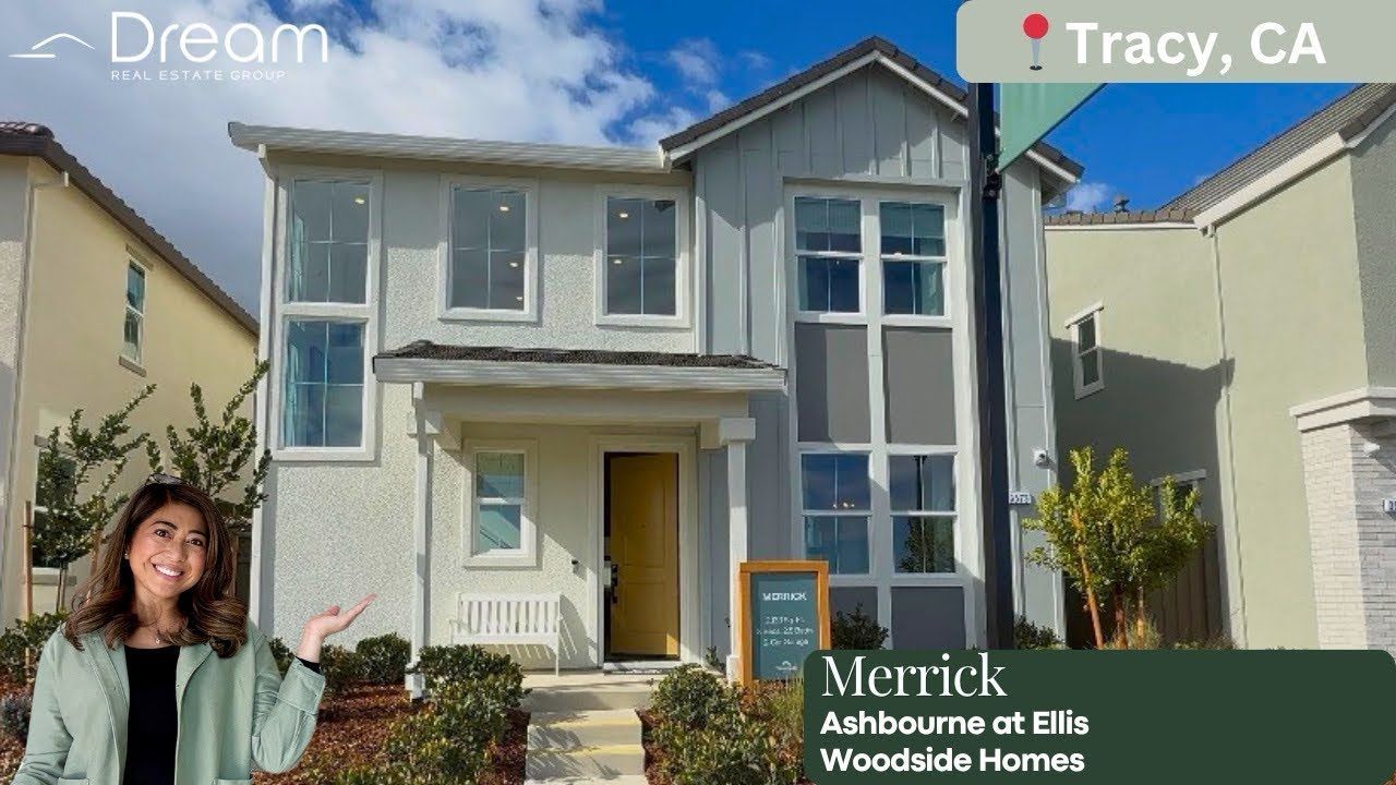 Two-story gray house with yellow door in Tracy, CA, labeled Merrick neighborhood homes