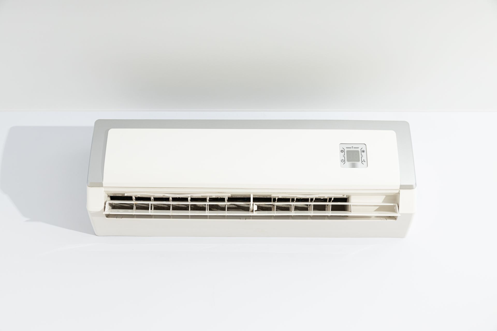 White wall-mounted air conditioner against a light background