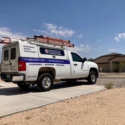 White service truck parked in front of a house on a sunny day. Truck has ladder on top and company logo.