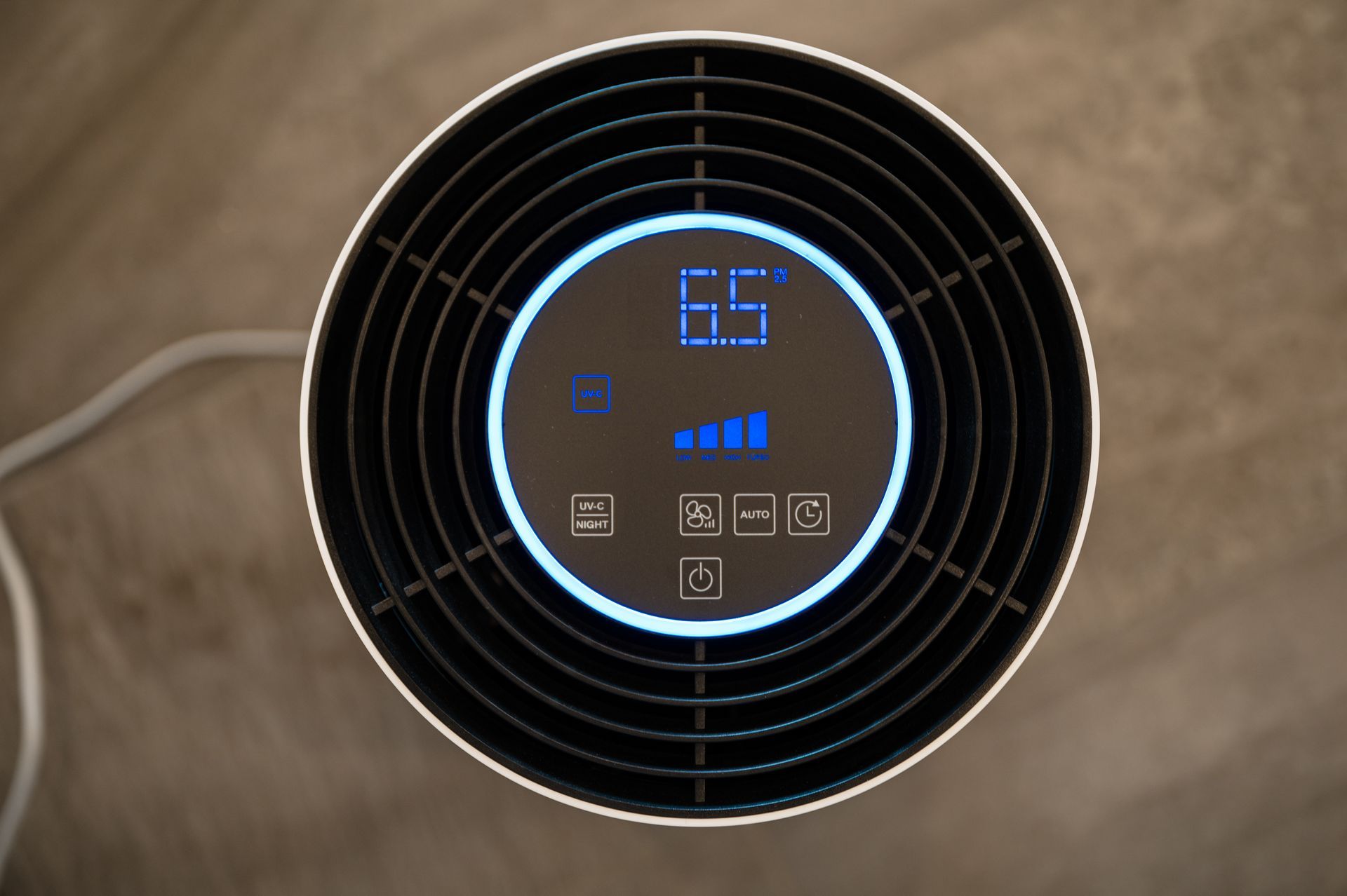 Top-down view of an air purifier with a digital display showing
