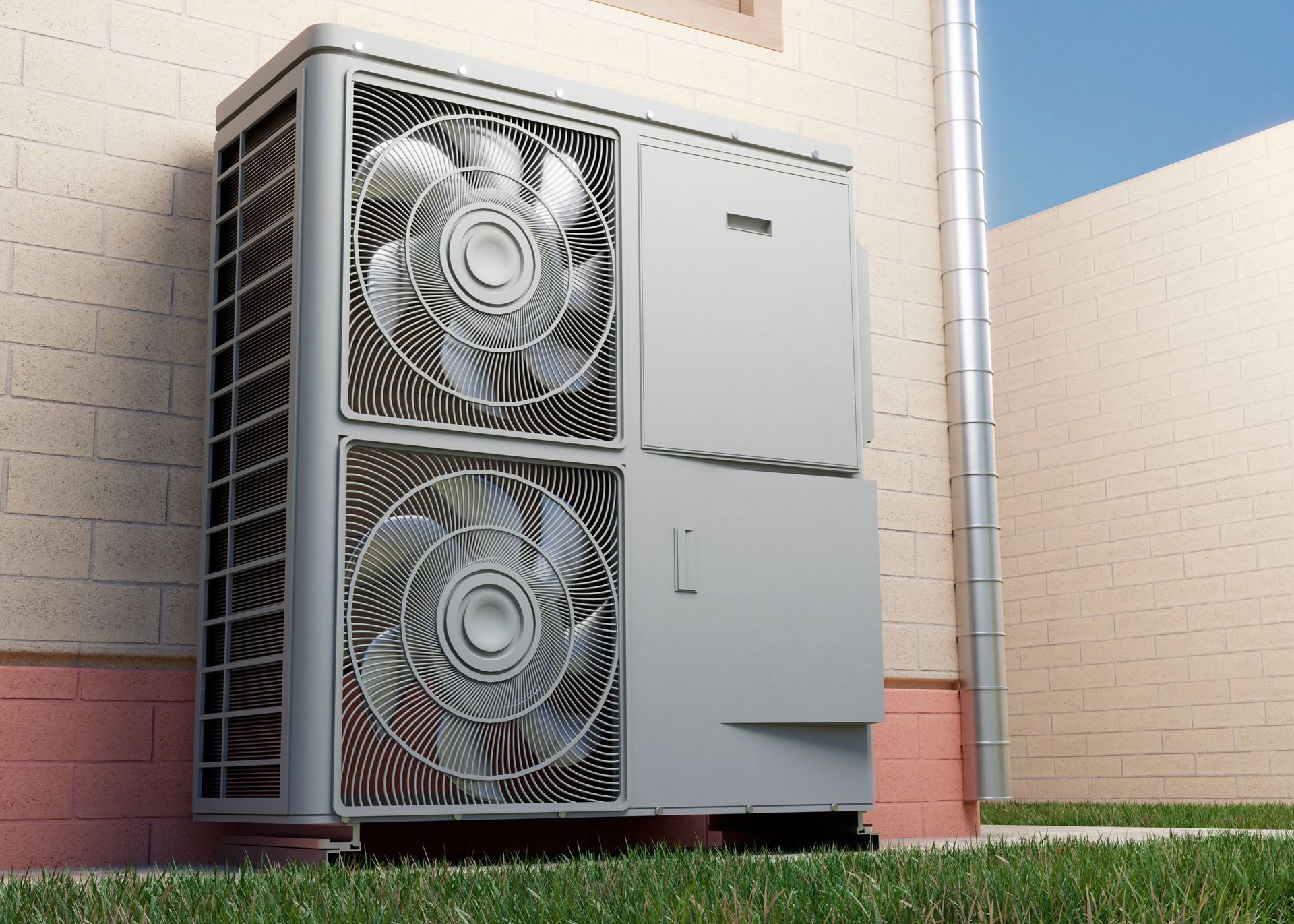 An exterior heat pump unit mounted on a brick wall with two visible fans, grass, and a blue sky.