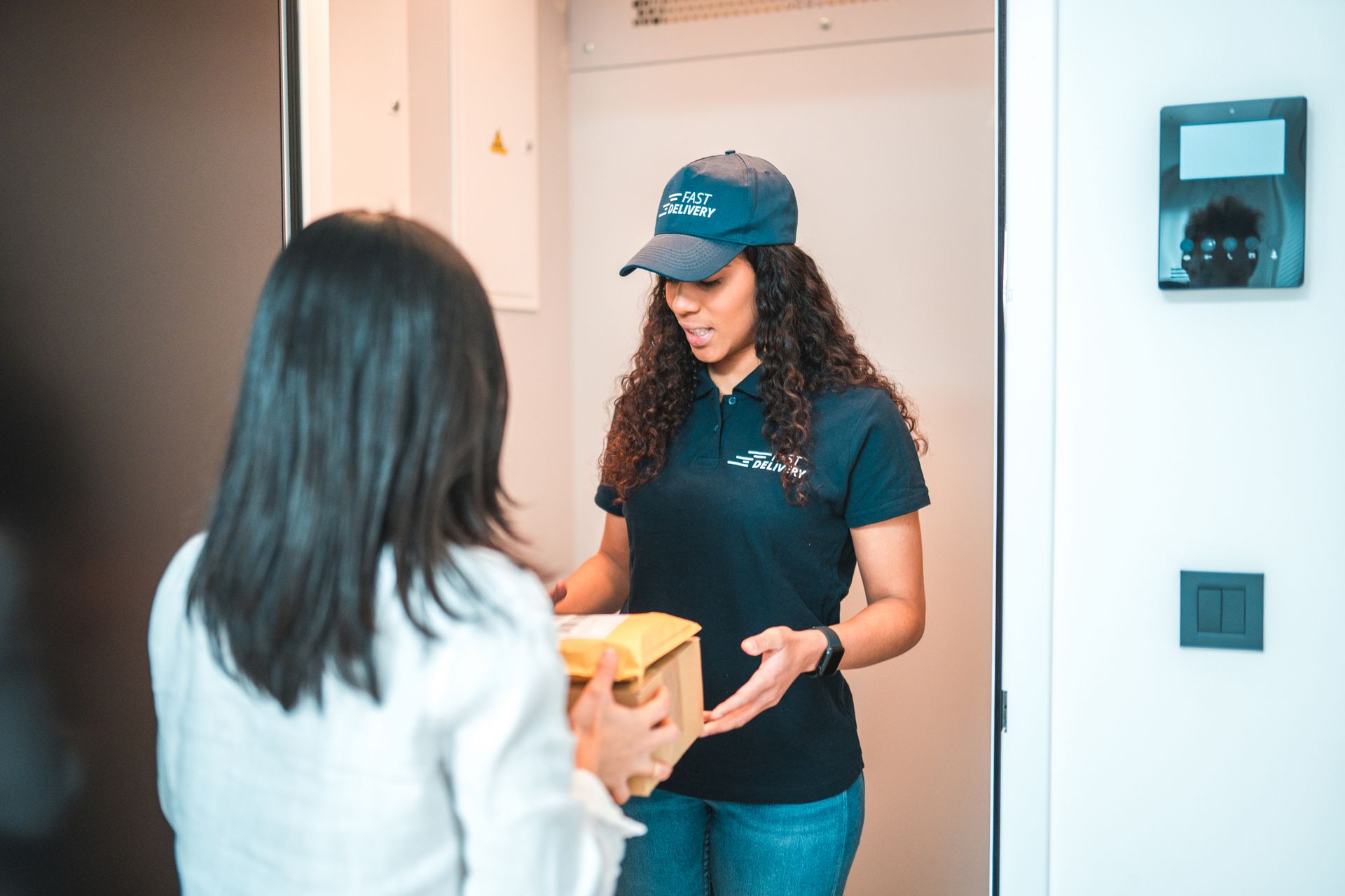Airport worker loading luggage onto a plane, wearing a safety vest, red shirt, and glasses. Airport worker loading luggage onto a plane, wearing a safety vest, red shirt, and glasses.