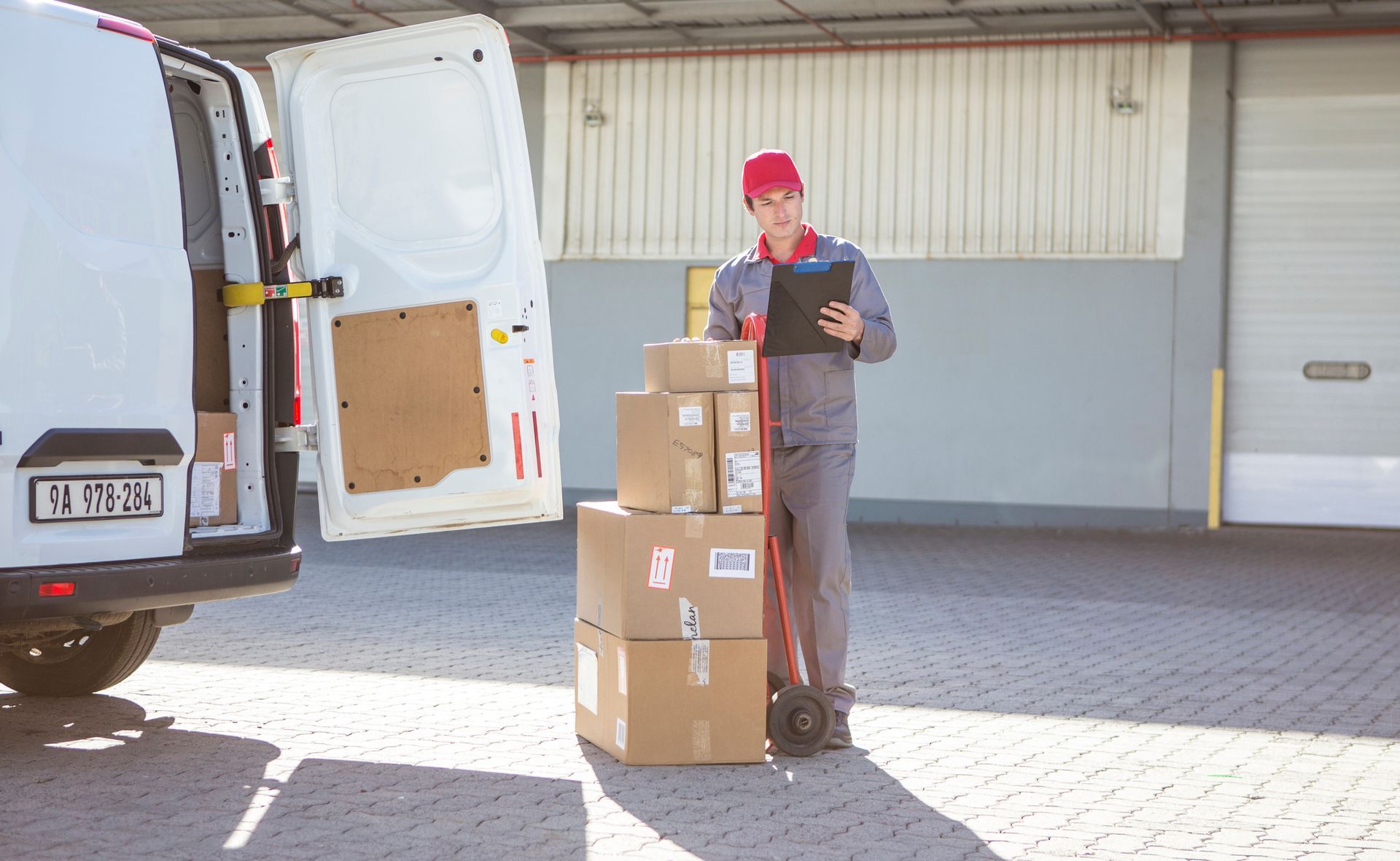 People with luggage, possibly at a transportation hub. Suitcases are grey, black, and light in color.