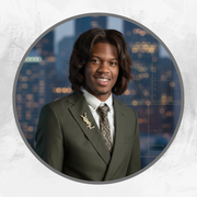 A smiling person in an olive green suit and tie with a gold YSL lapel pin, set against a blurred city skyline backdrop.
