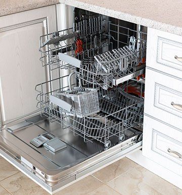 A dishwasher is open and filled with dishes and utensils.