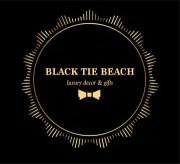 Gold circular logo on black background. Text reads "Black Tie Beach, luxury decor & gifts" with a bow tie icon.