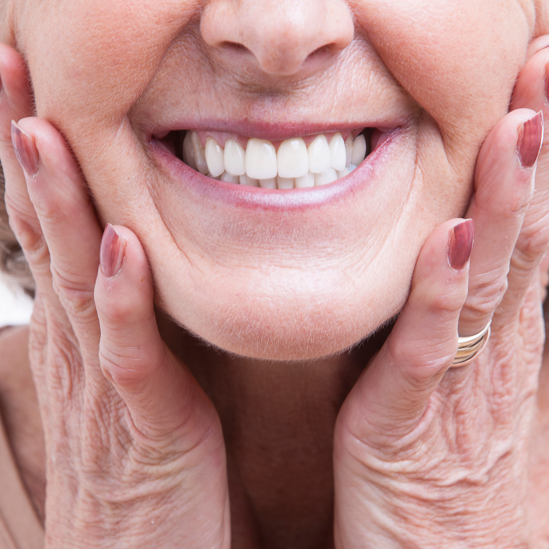 Woman holding mouth | Dentures in Mt. Pleasant SC