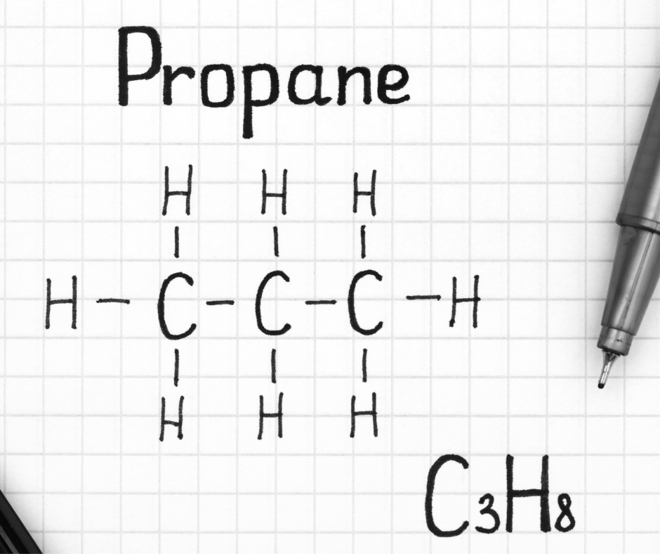 The chemical structure of propane is written on a piece of graph paper next to a pen.