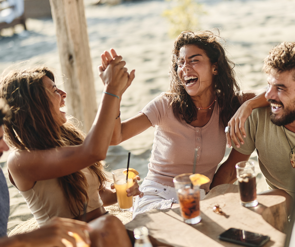 Friends enjoying carbonated drinks on a sunny patio.