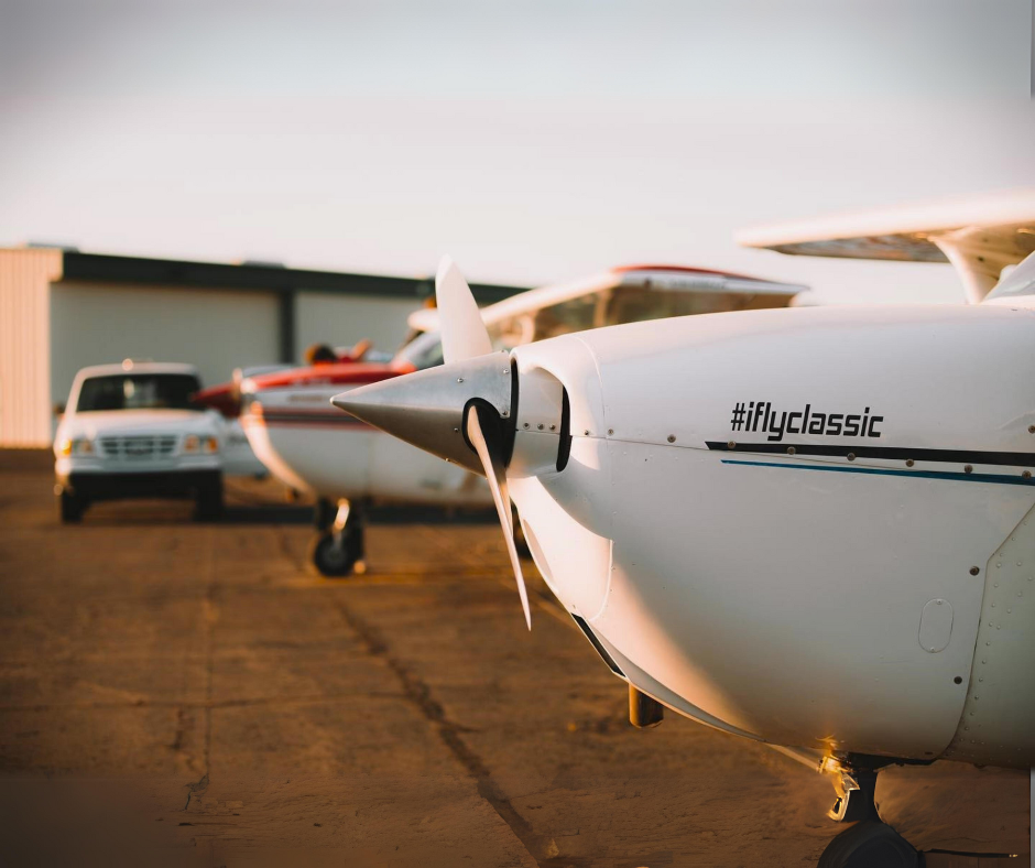 Small aircraft with the hashtag #iflyclassic on the fuselage, parked on tarmac at sunset, highlighting Metro Welding Supply Corp's specialty gases in aviation.