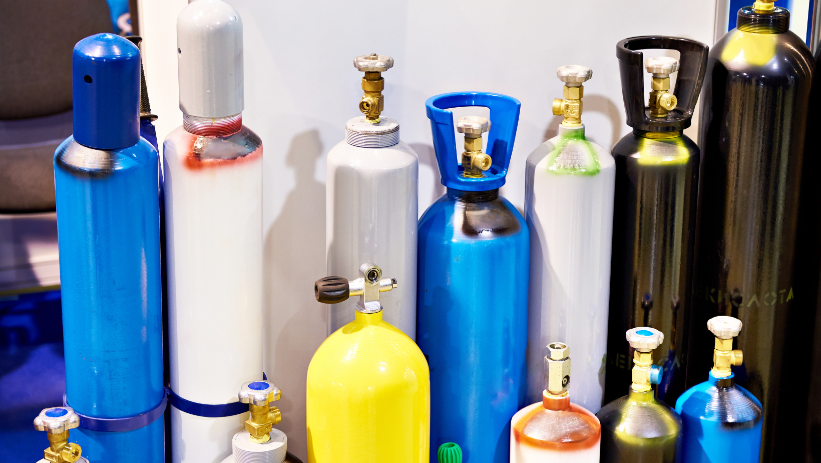 Colorful gas cylinders with valves, for industrial and medical use.