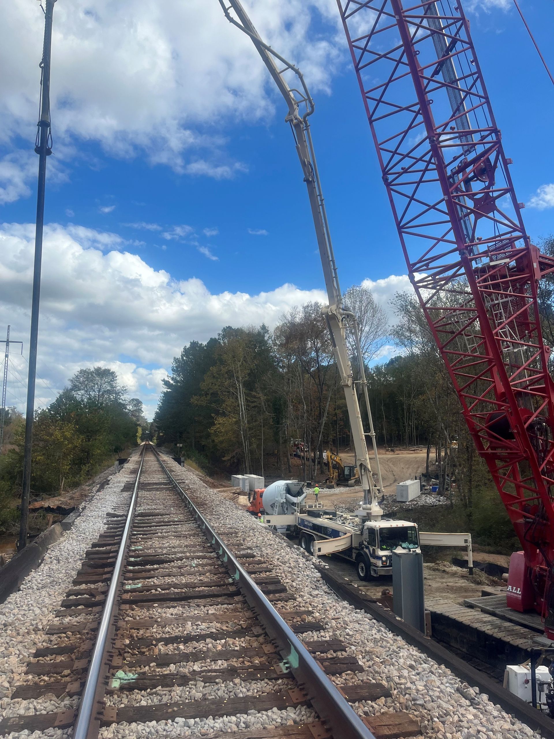 A Train Track with a Red Crane in The Background | Tallapoosa, GA | Taylor-Made Pumping