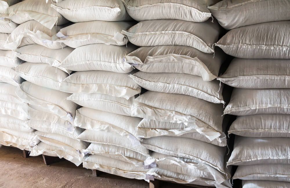 A Pile of Bags Stacked on Top of Each Other in A Warehouse — Hazells Farm & Fertilizer Services in Taminda, NSW