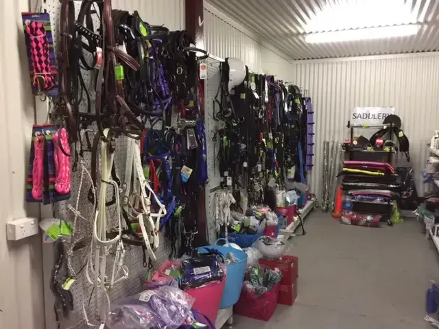 A Room Filled with Lots of Horse Equipment and Bridles — Hazells Farm & Fertilizer Services in Taminda, NSW