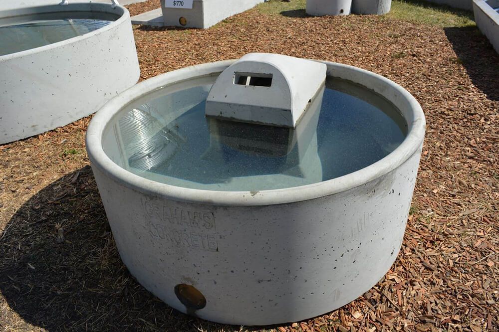 Water Is Coming out Of a Pipe Into a Bucket — Hazells Farm & Fertilizer Services in Taminda, NSW