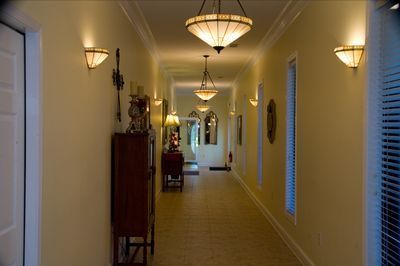 a long hallway with lots of lights hanging from the ceiling
