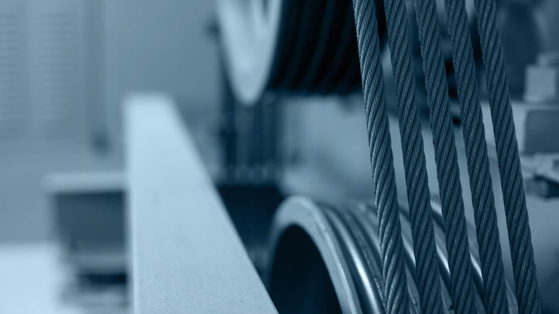 A close up of a rope on a machine in a factory.