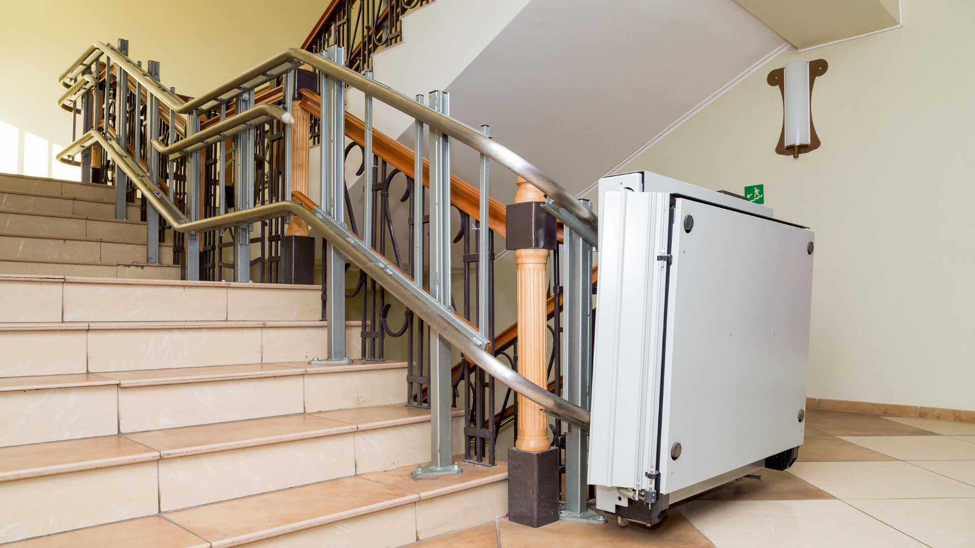 A stair lift is sitting next to a set of stairs.