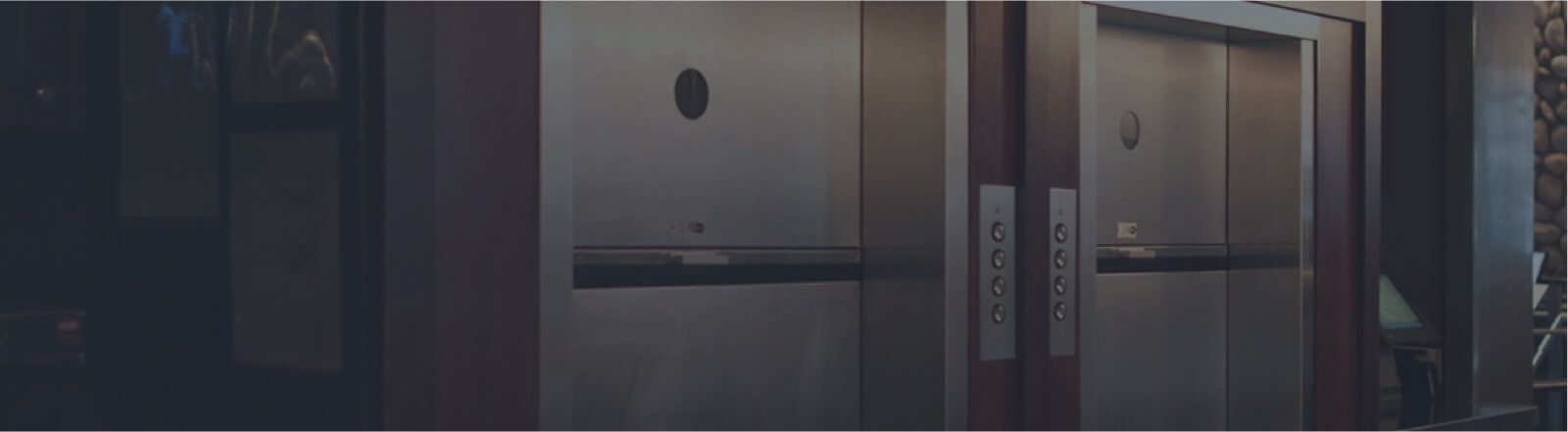 A blurry picture of a row of elevators in a building.