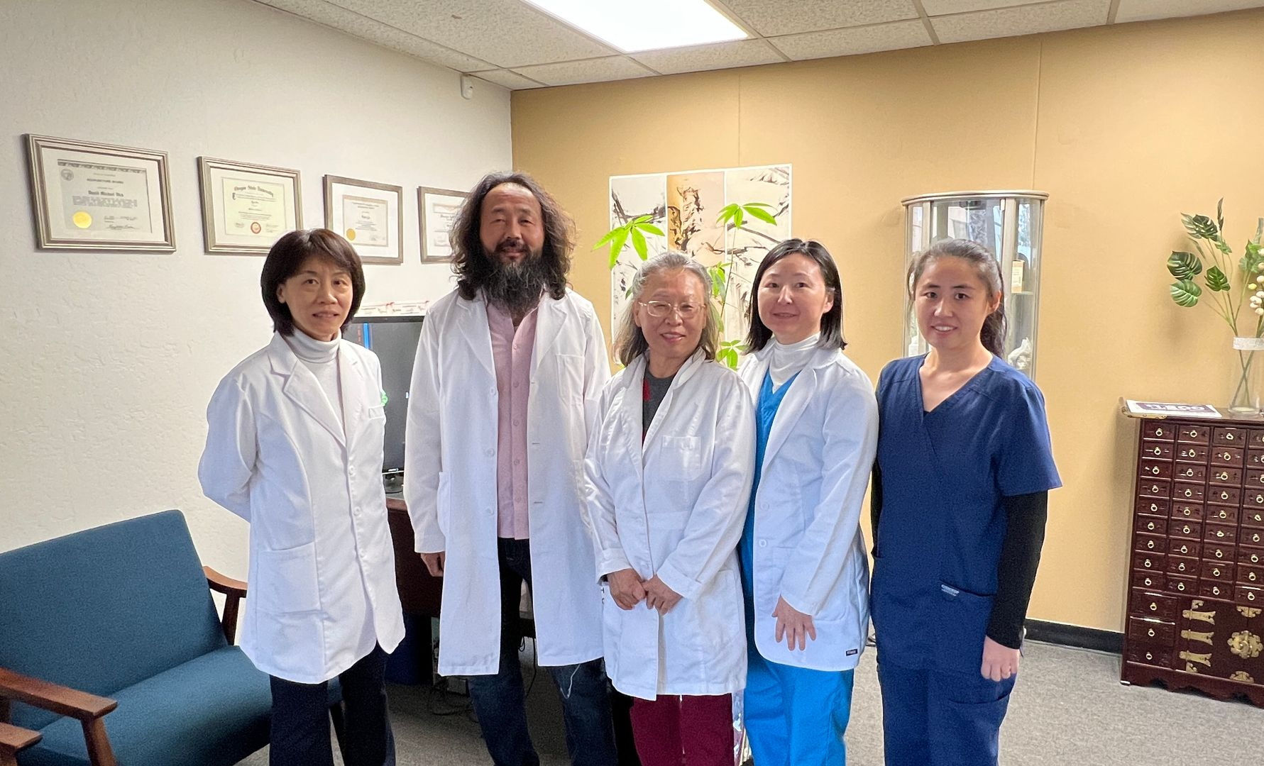 a woman is sitting on a bed with her legs crossed and smiling