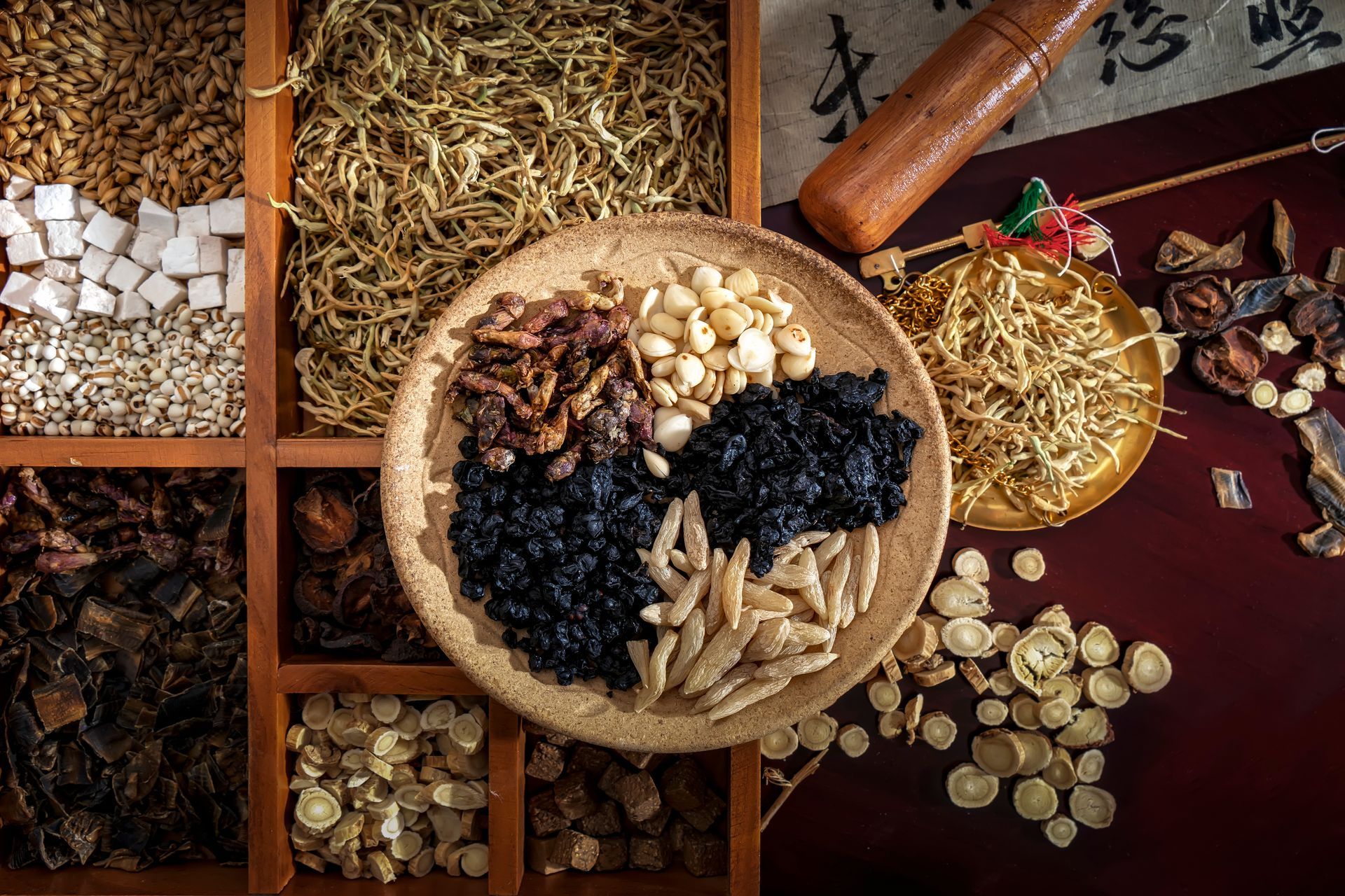 a wooden box filled with a variety of dried chinese herbs