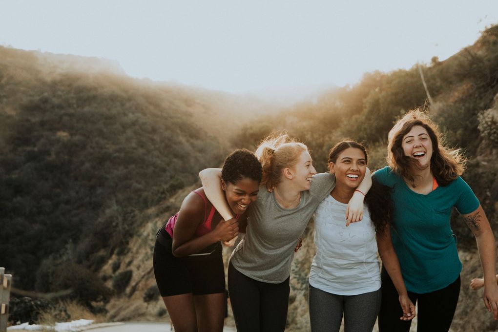 three women are posing for a picture and smiling for the camera