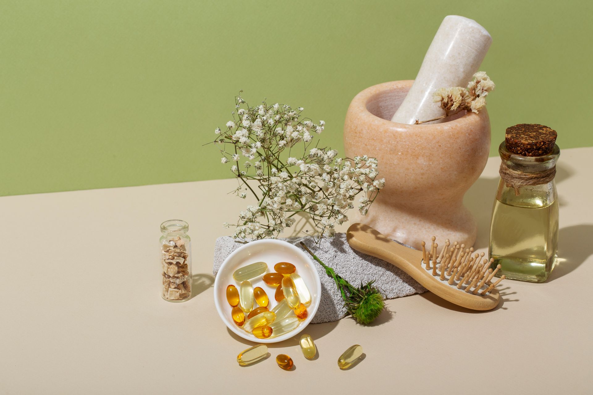 a mortar and pestle next to a bowl of pills and a brush