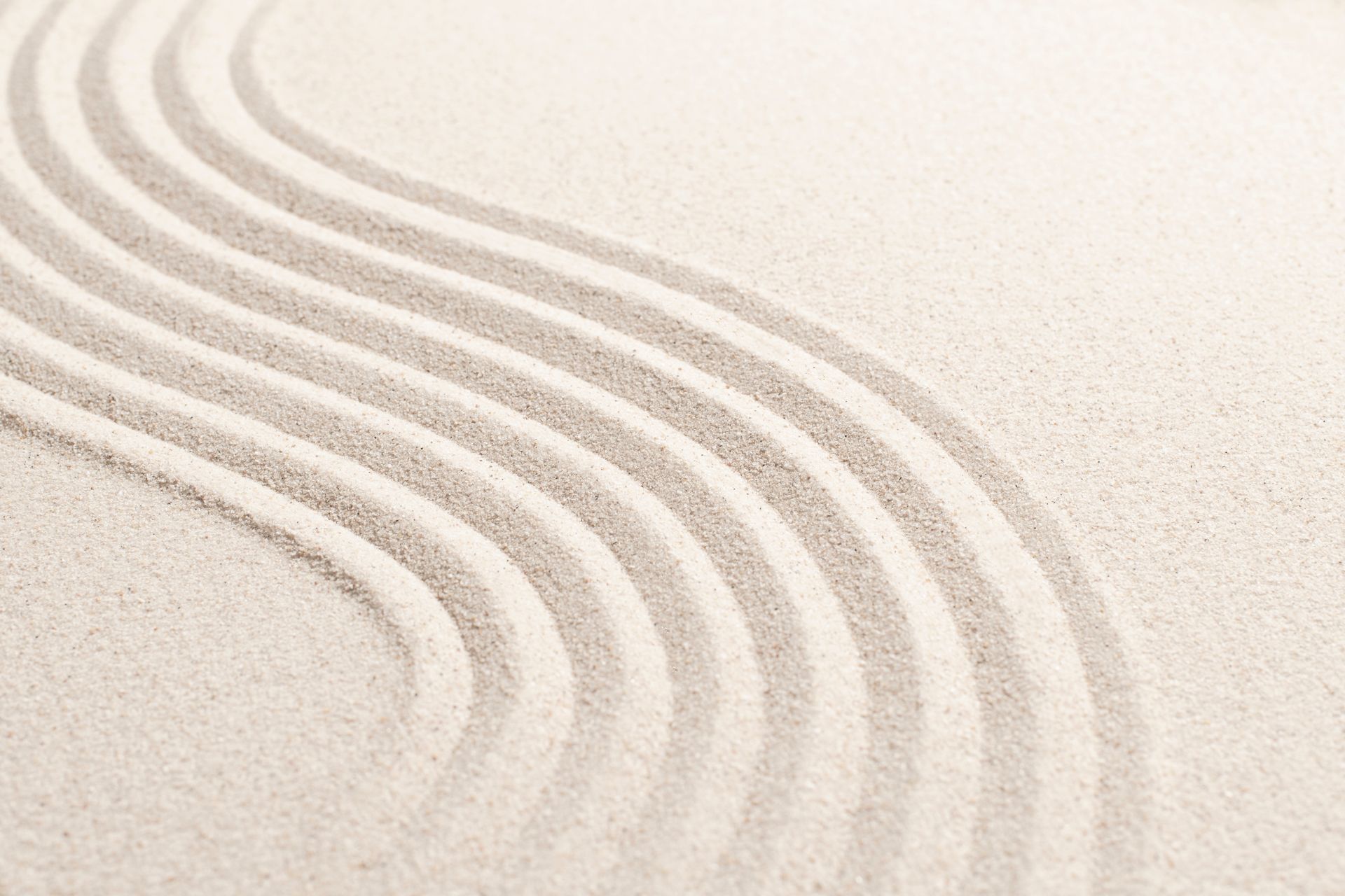 a close up of a sandy surface with a wave pattern