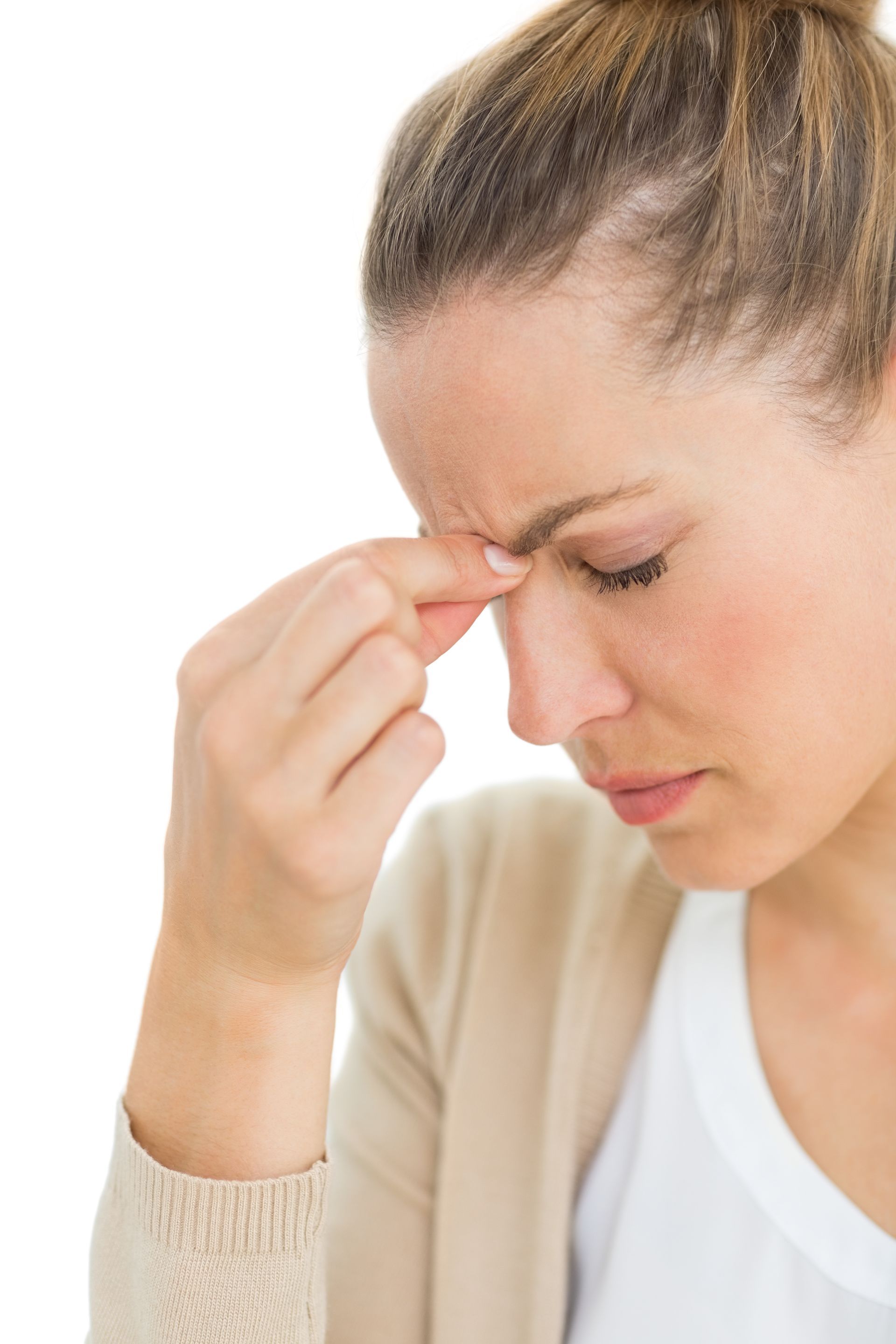 a woman holds her nose because she has a headache