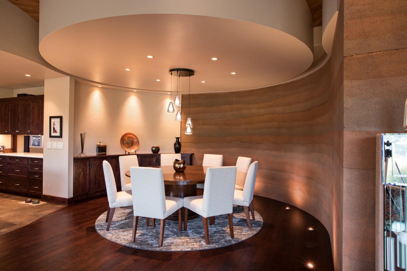 Round dining room with curved SIREWALLs off of kitchen.