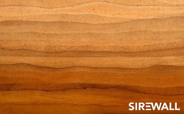 Close up of a SIREWALL rammed earth wall with beautiful layers of rammed earth with slightly varying colors