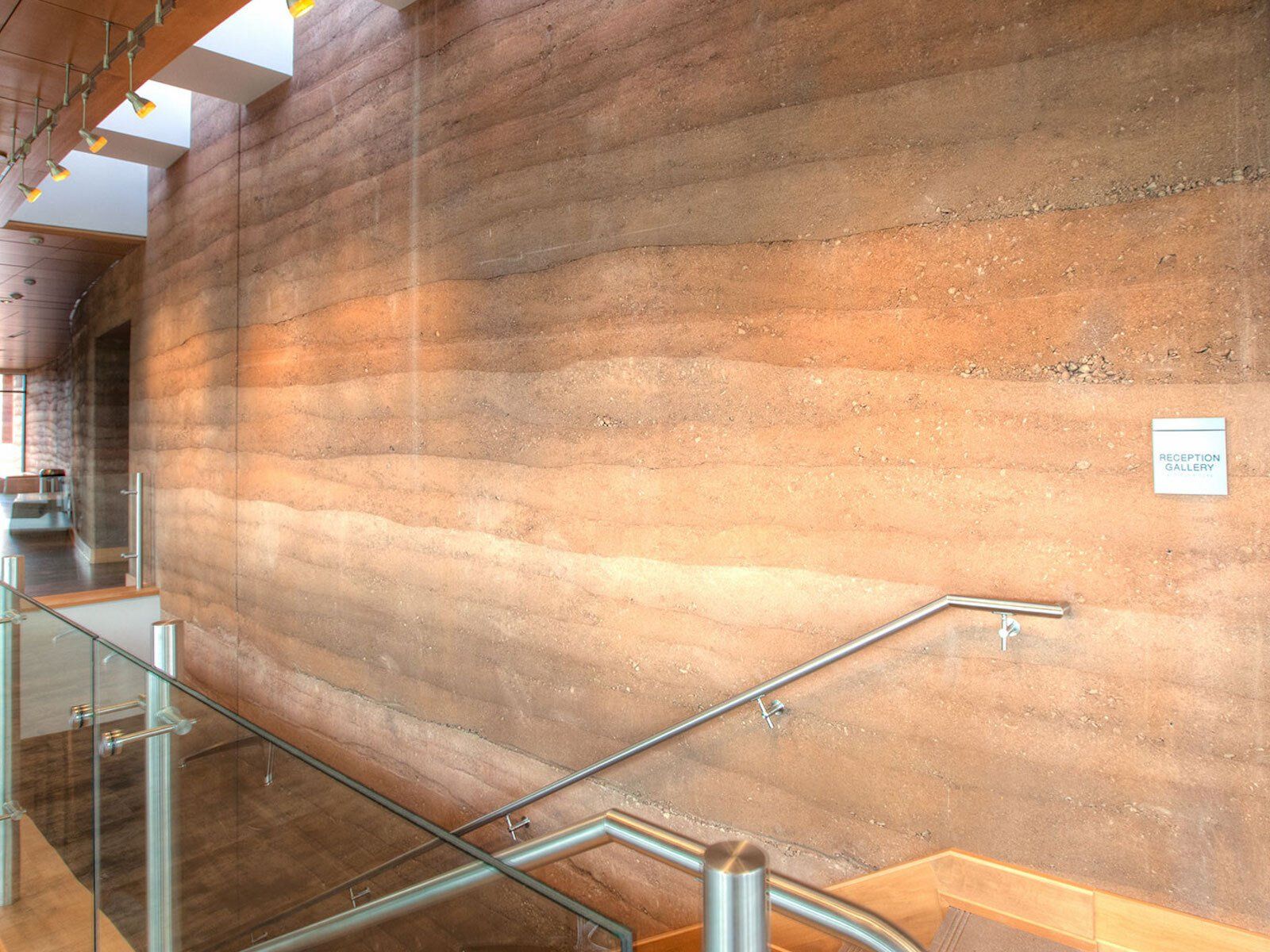 Brinton Museum interior stairway with large rammed earth SIREWALL