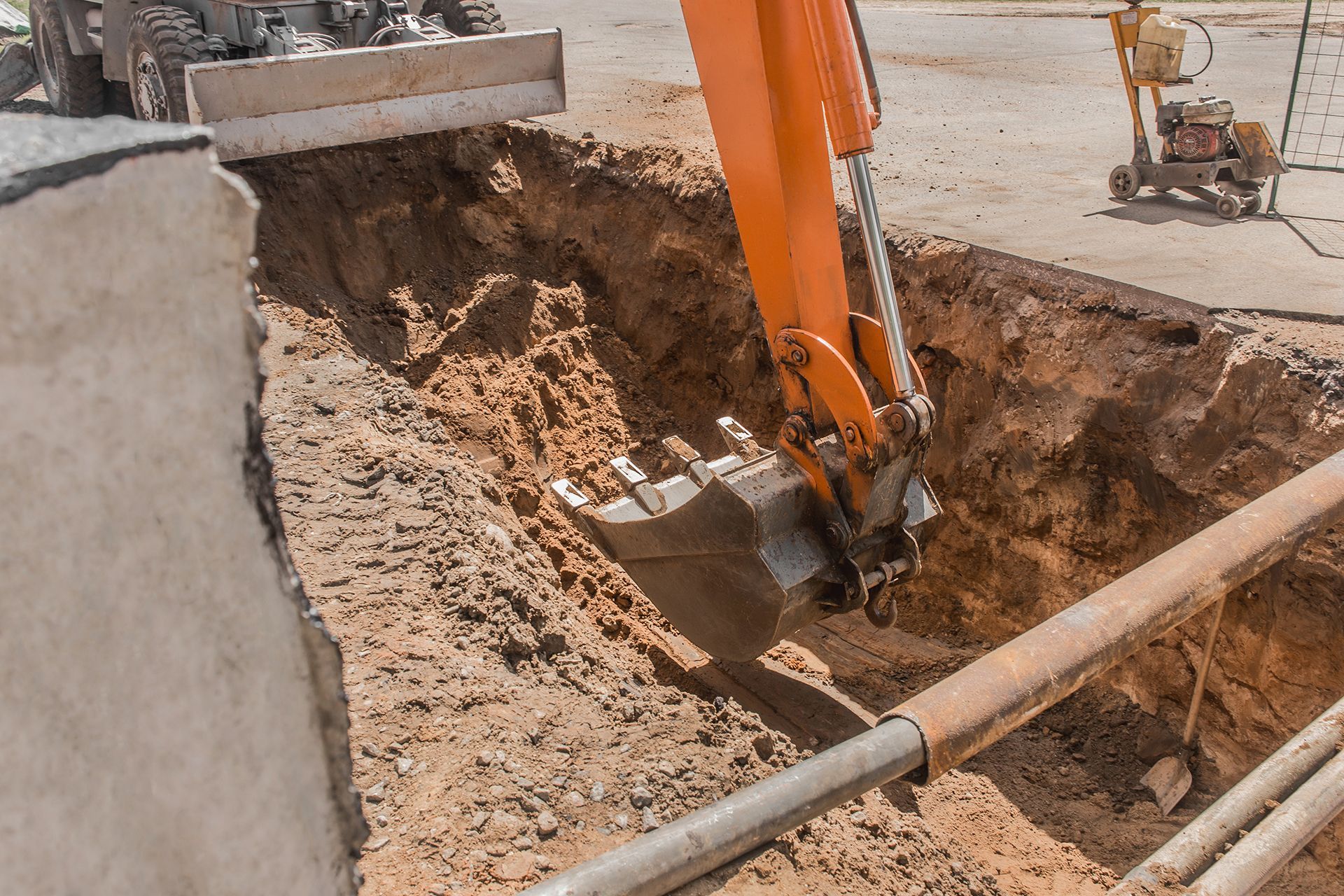 an orange excavator is digging a hole in the ground