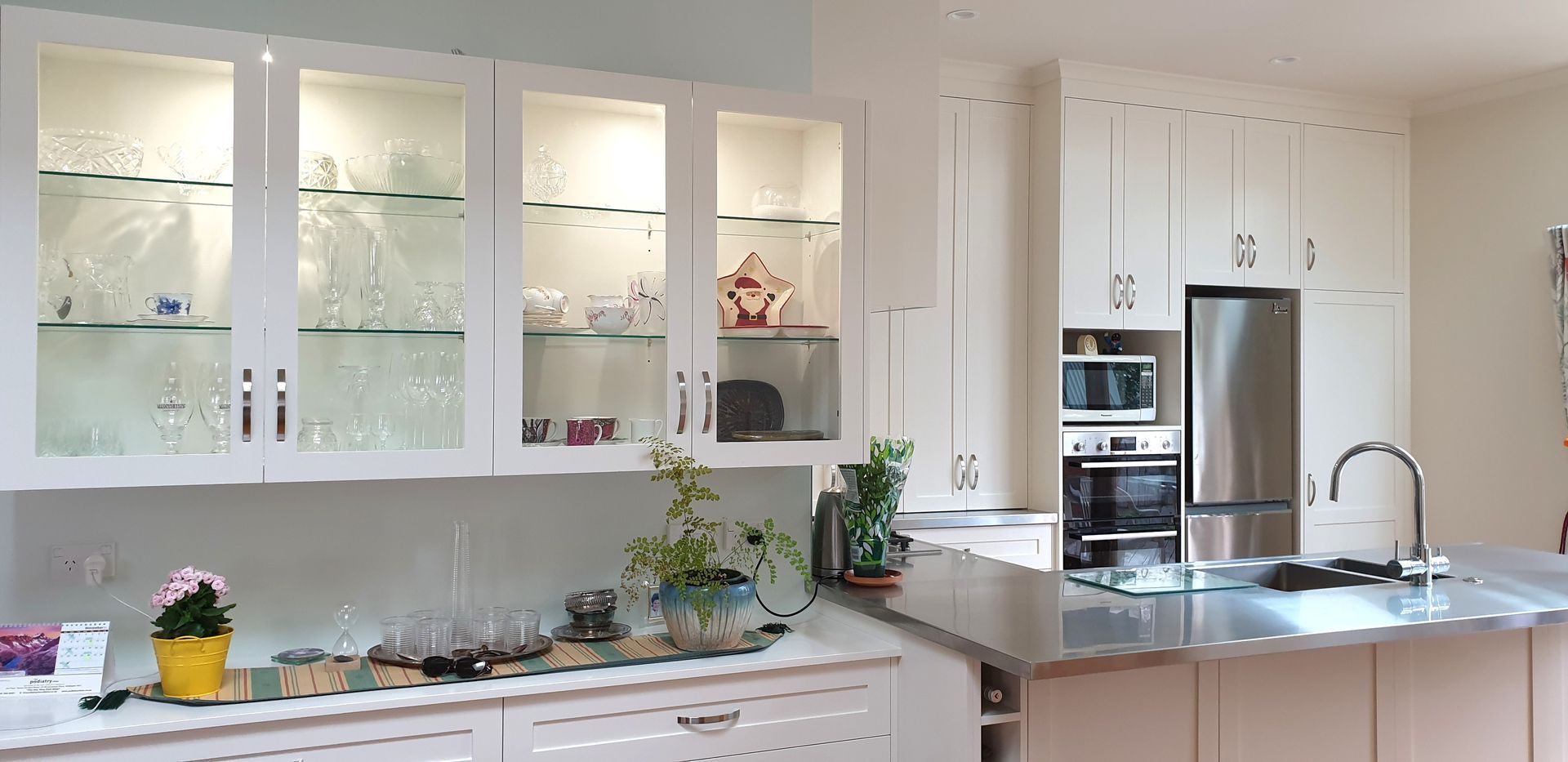 A kitchen with white cabinets and stainless steel appliances