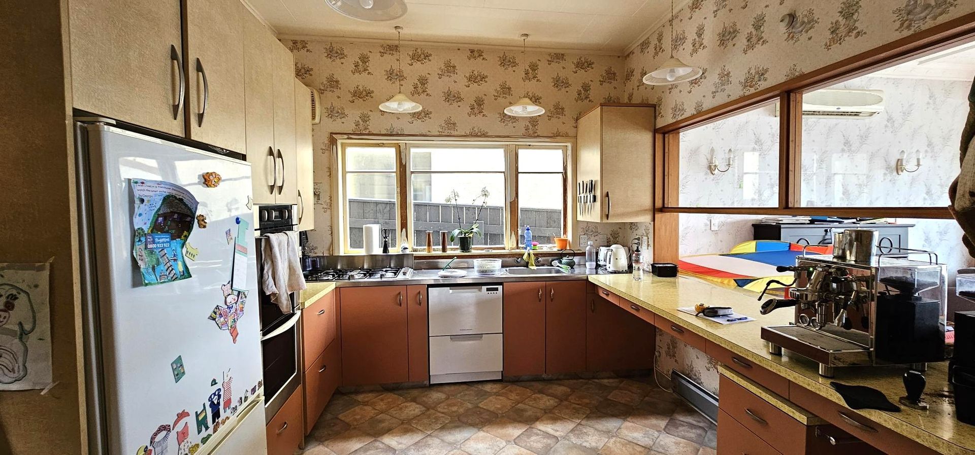 A kitchen with a refrigerator that has a picture of a dog on it.