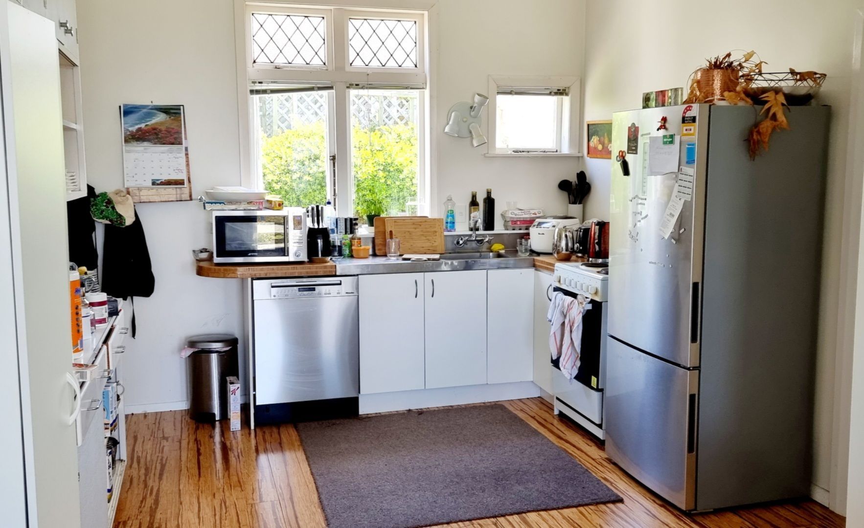 A kitchen with a stainless steel refrigerator and dishwasher
