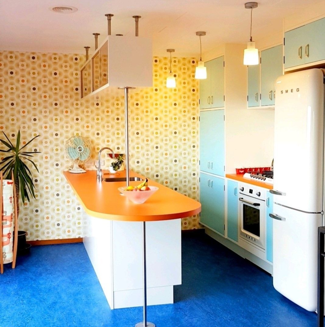 A kitchen with a fridge that says smeg on it