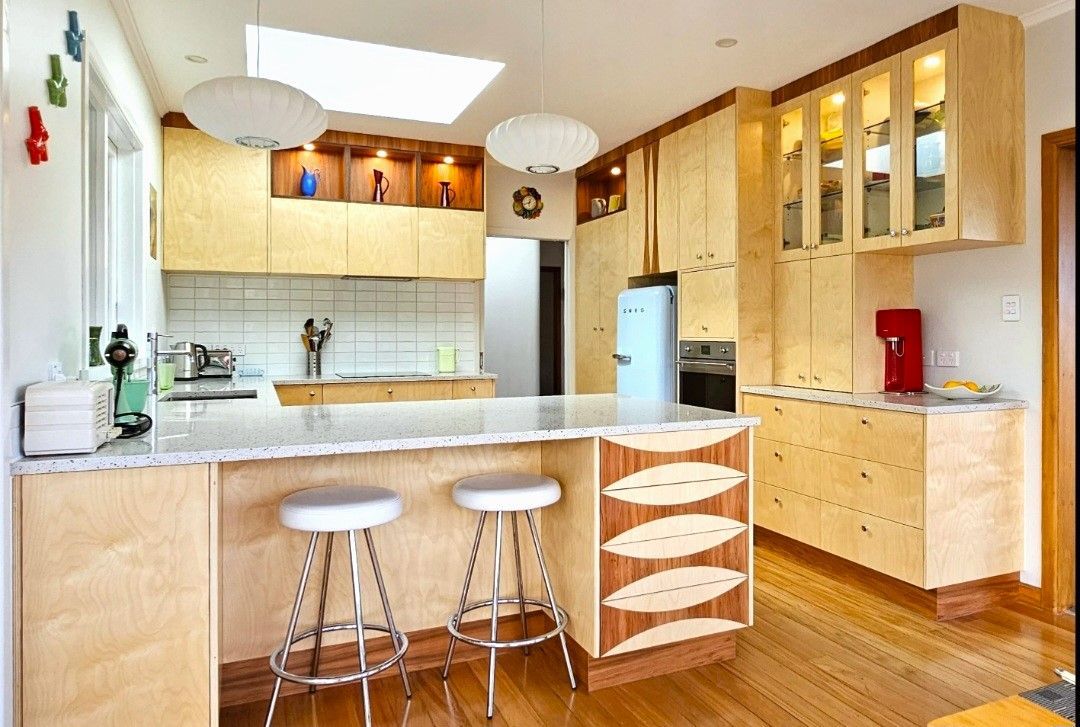 A kitchen with wooden cabinets and a blue refrigerator