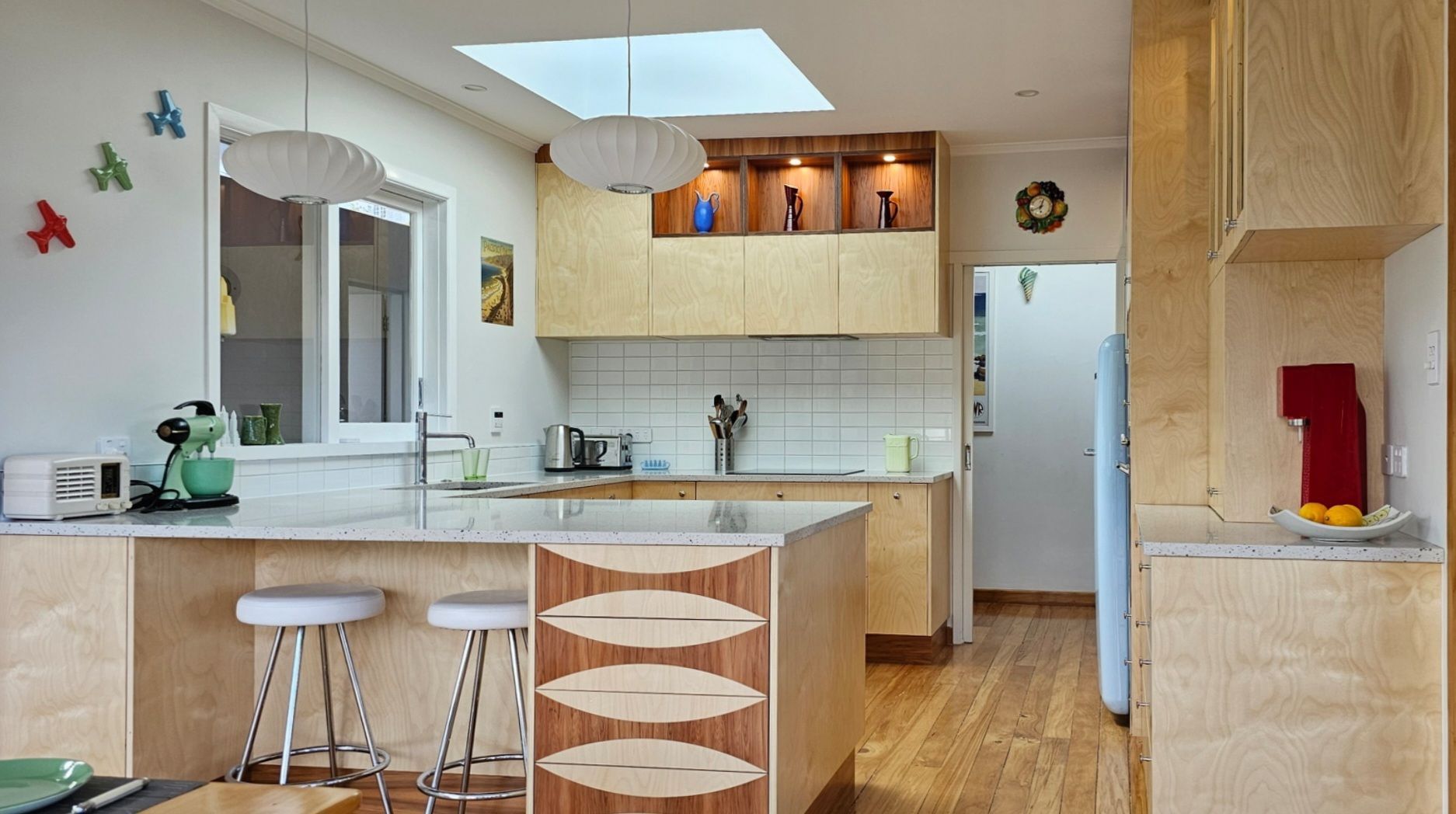 A kitchen with wooden cabinets and a large island