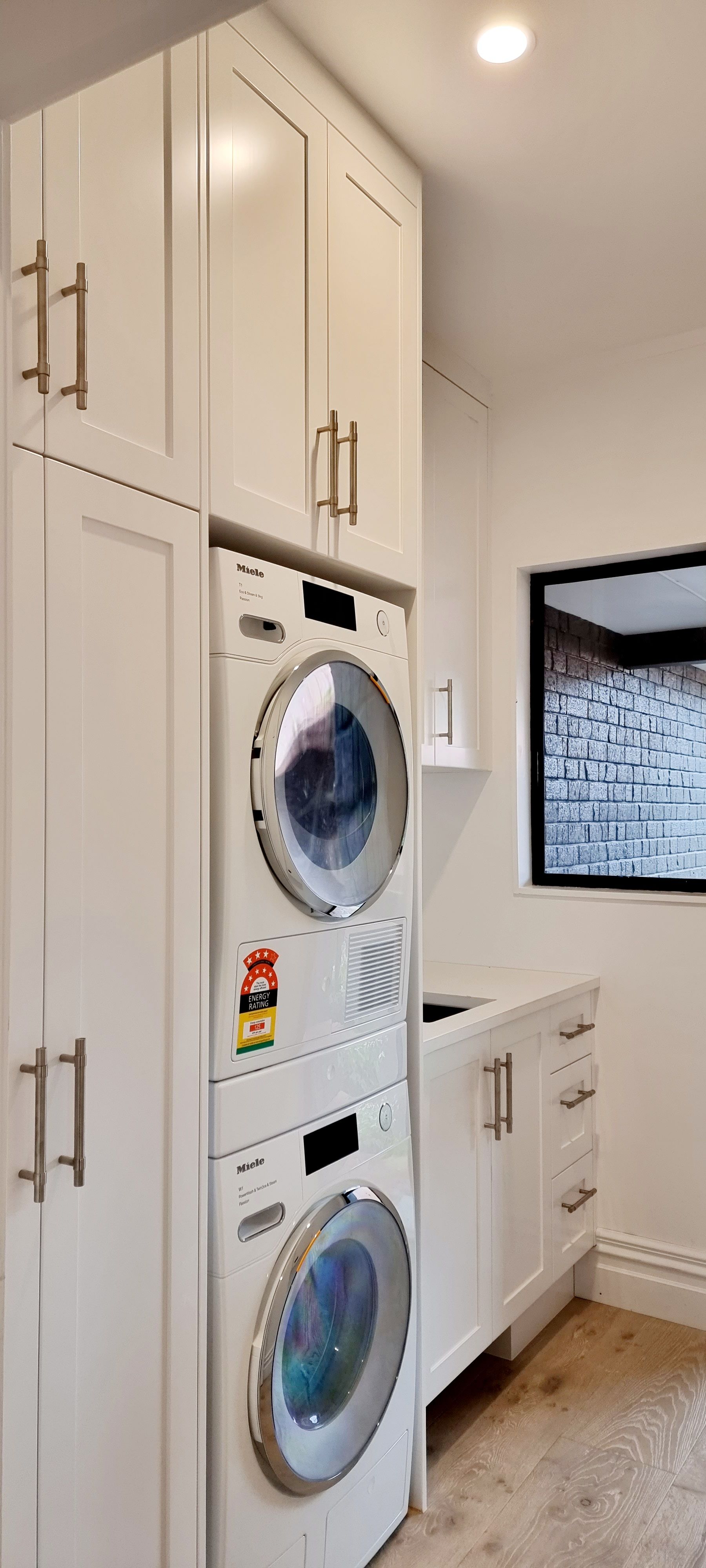 A laundry room with a washer and dryer stacked on top of each other.