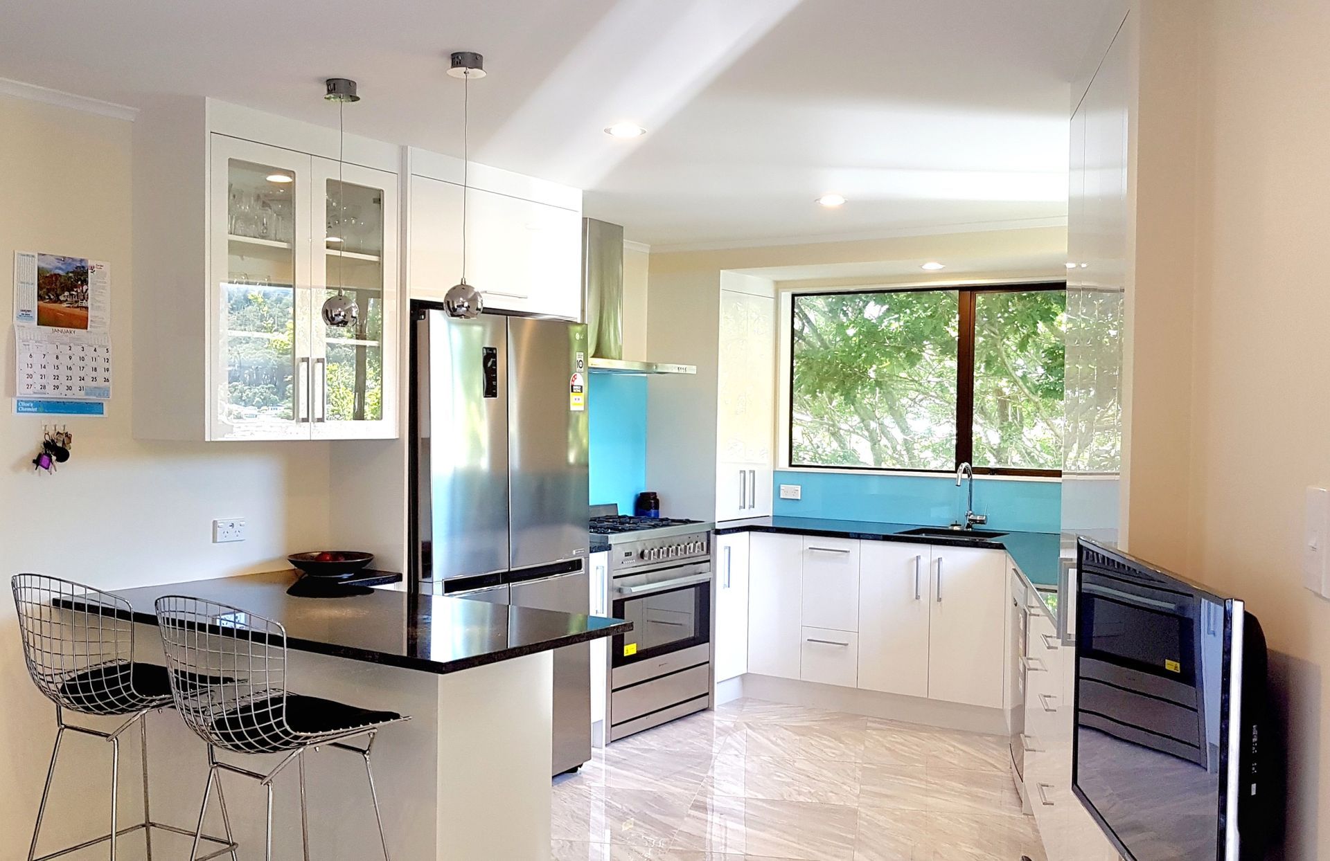 A kitchen with white cabinets and stainless steel appliances