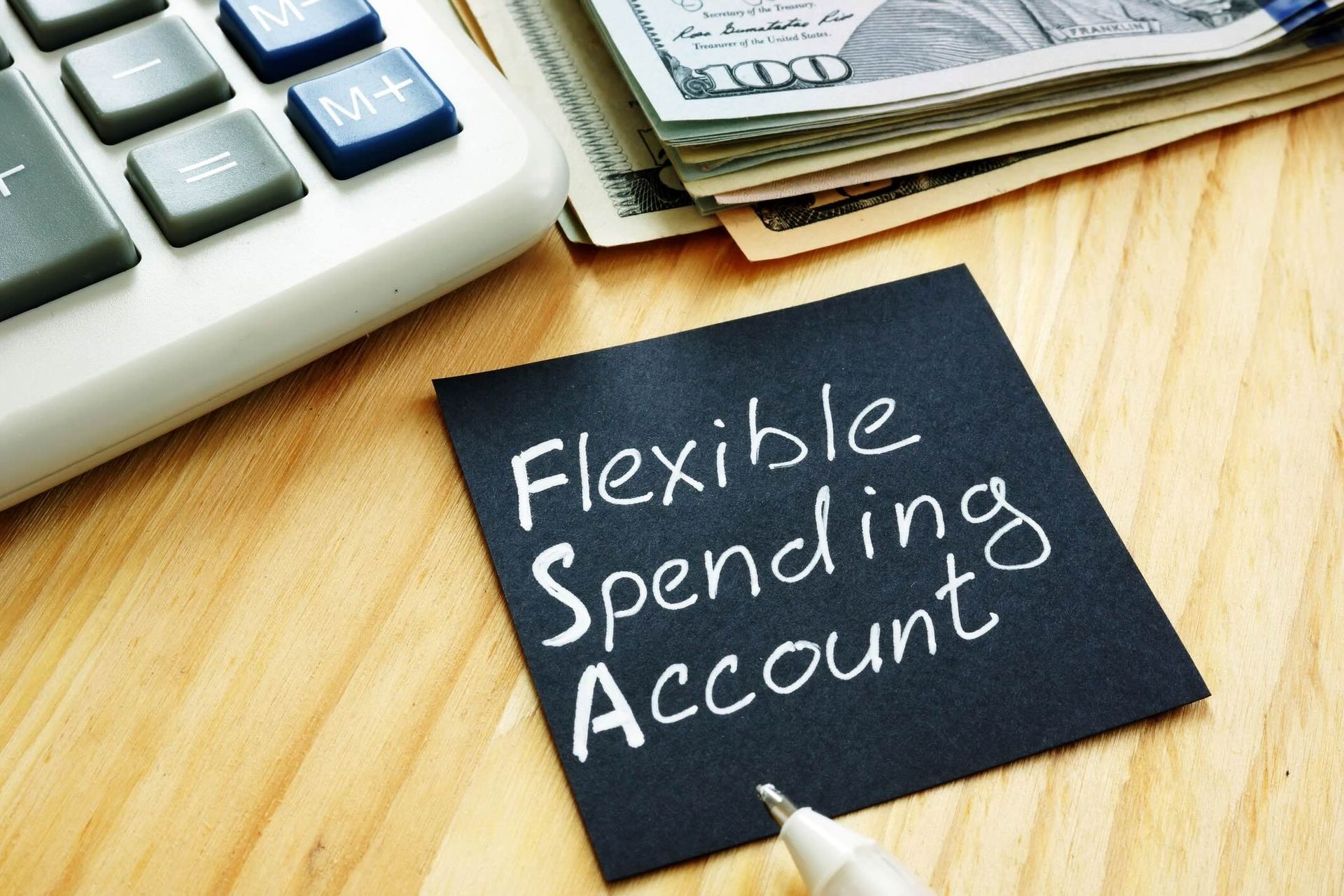 Flexible spending account FSA sign on a black piece of paper