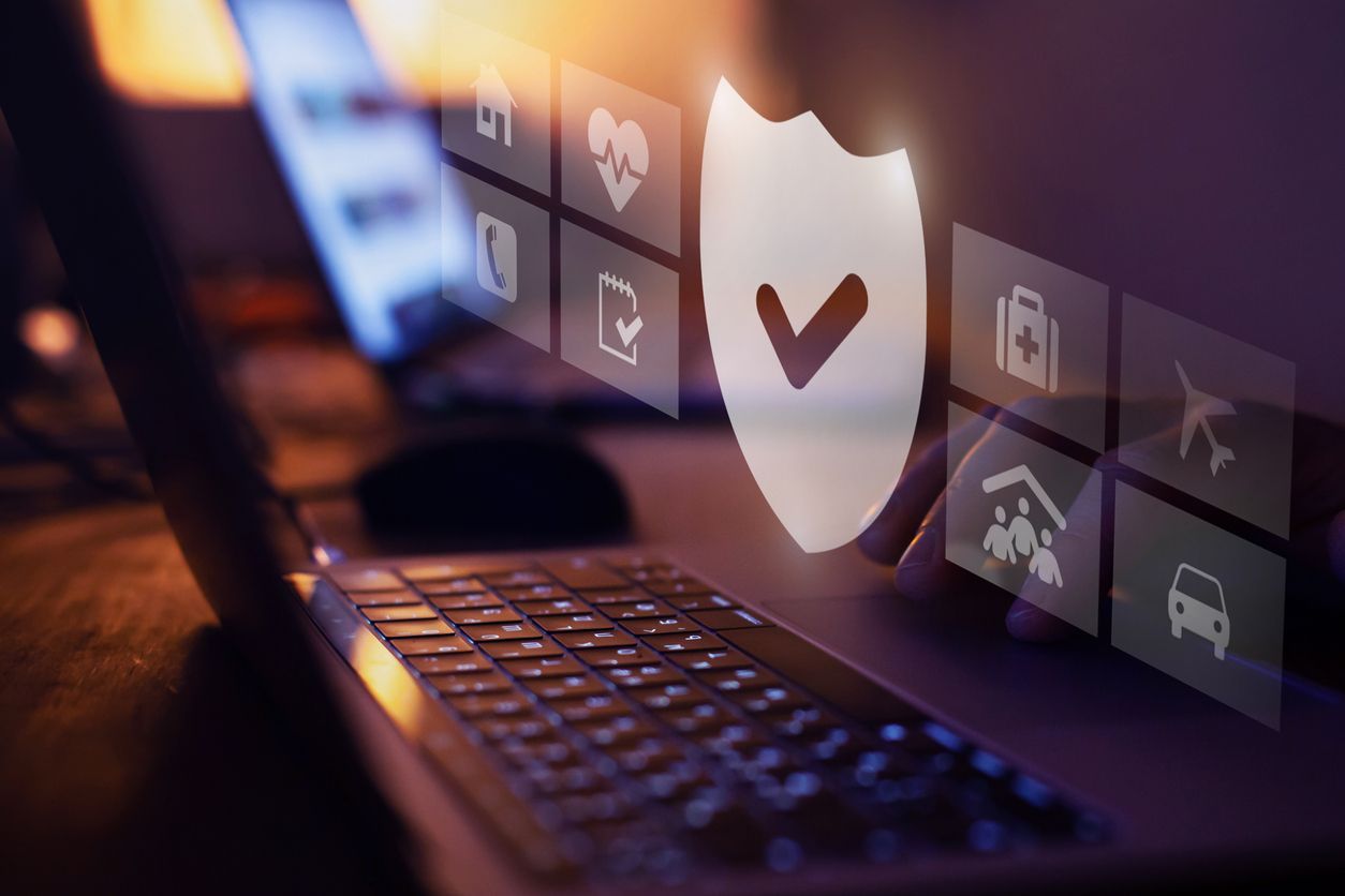 A checkmark icon appears in front of a person using a laptop.