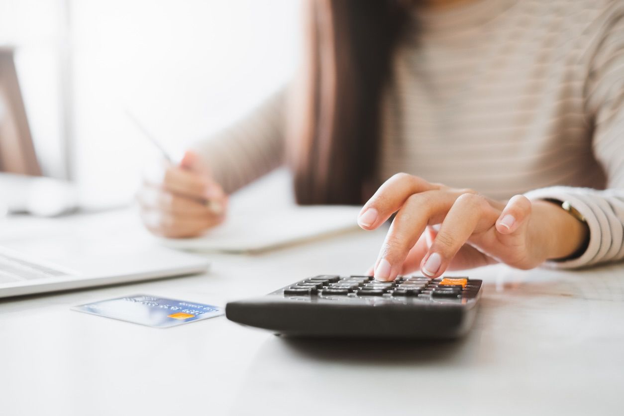 A woman uses a calculator to calculate her finances.