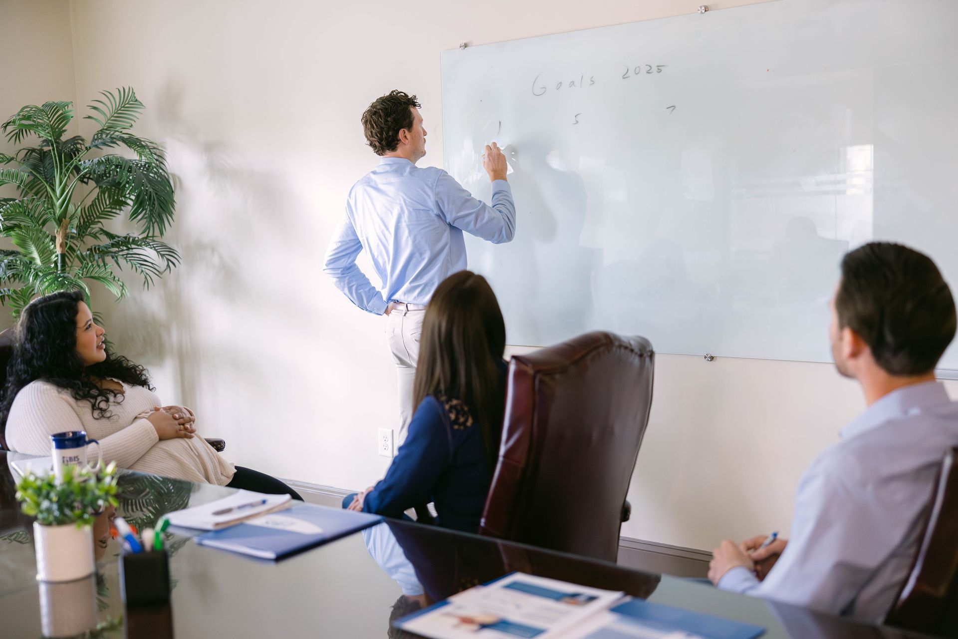 an employee benefits broker explaining coverages to employees at a table