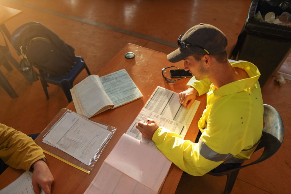construction foreman reviewing paperwork for construction insurance