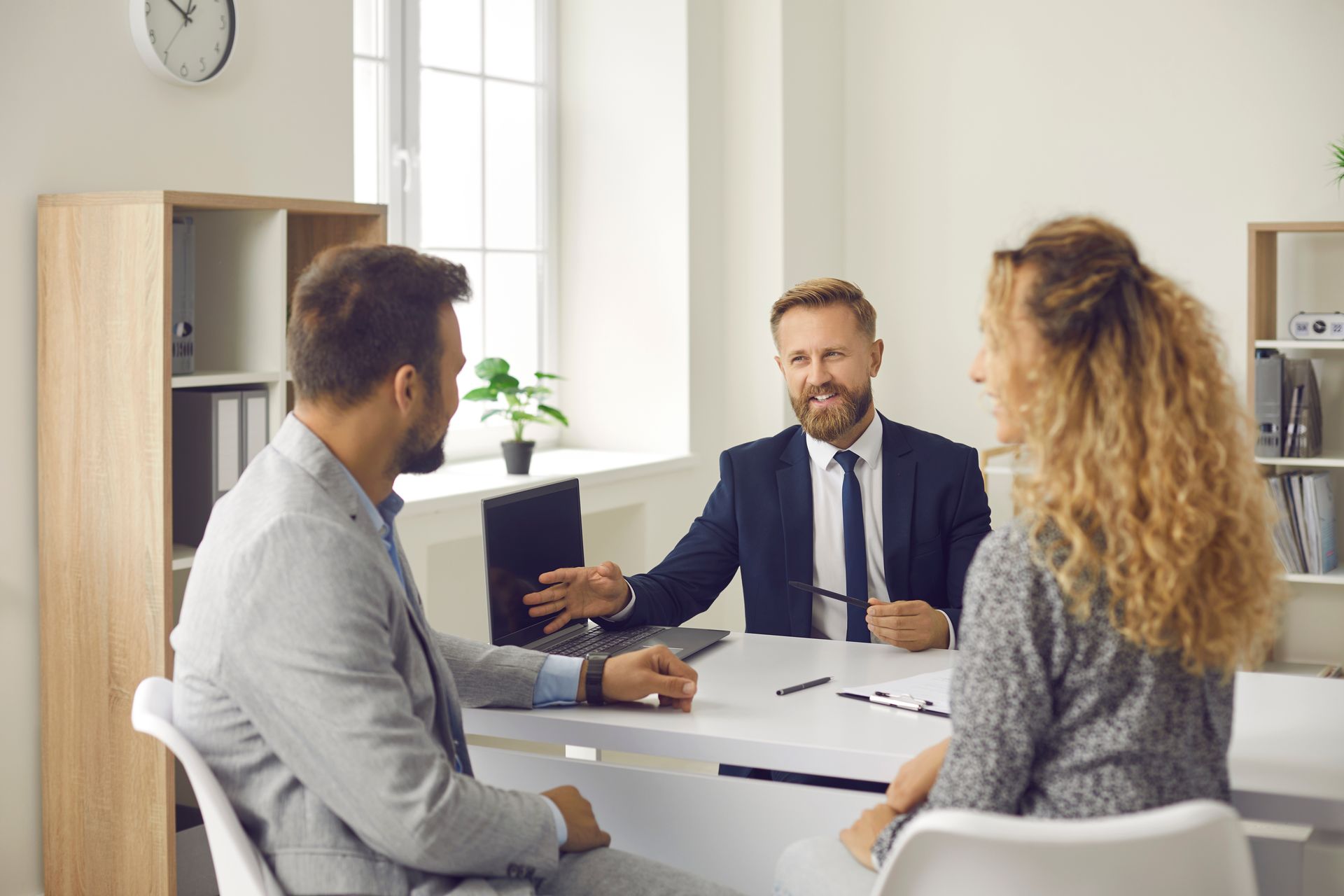 Two business owners are sitting at a table talking to a new insurance broker.