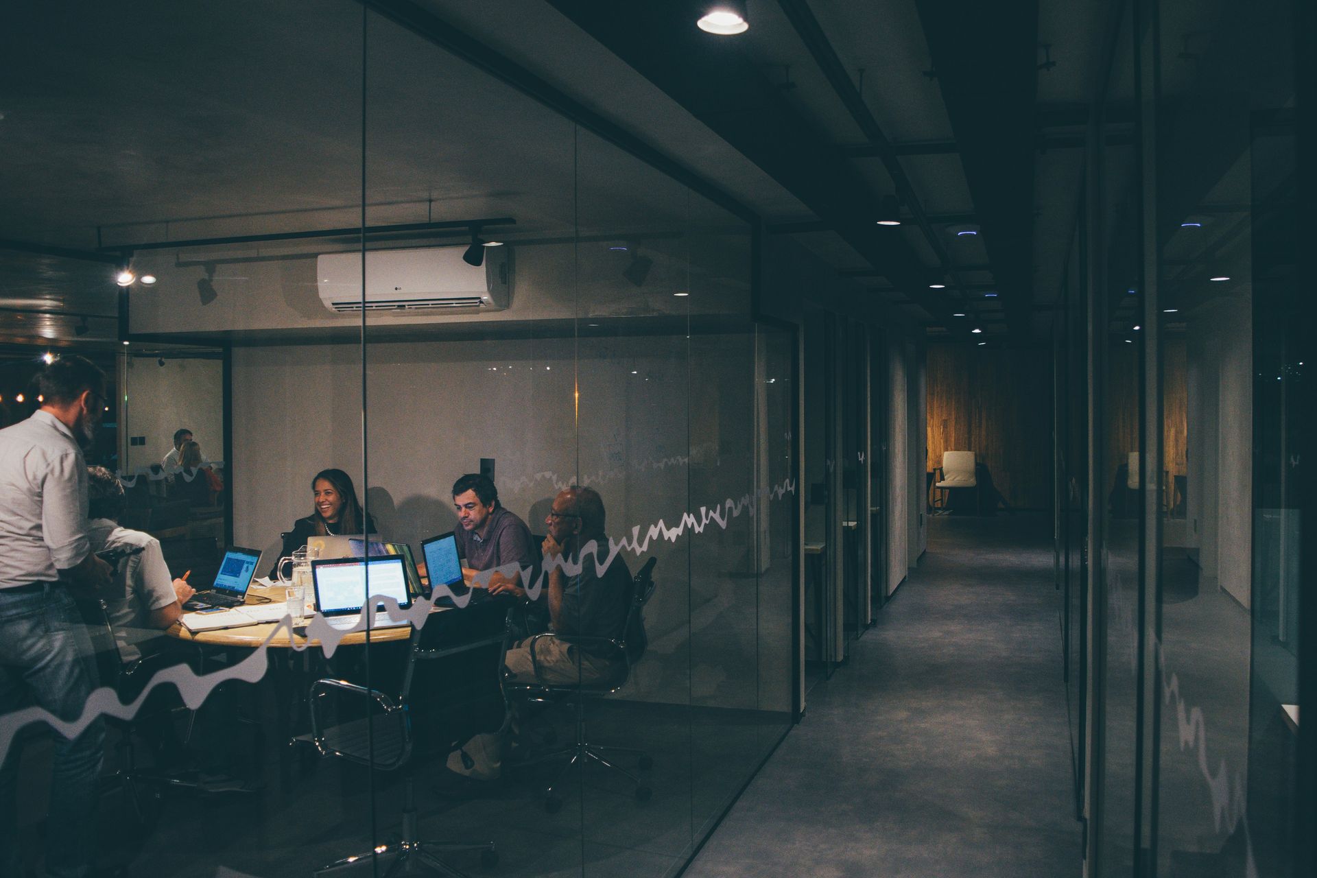 A group of people are sitting around a table in a conference room.
