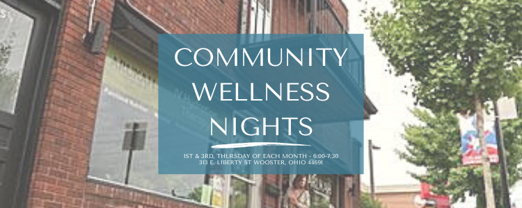 Sign for Community Wellness Nights on a brick building.