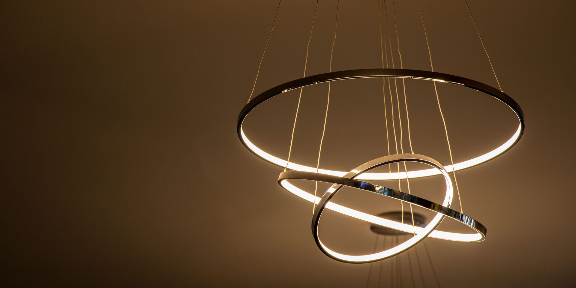 A chandelier with three rings hanging from the ceiling.